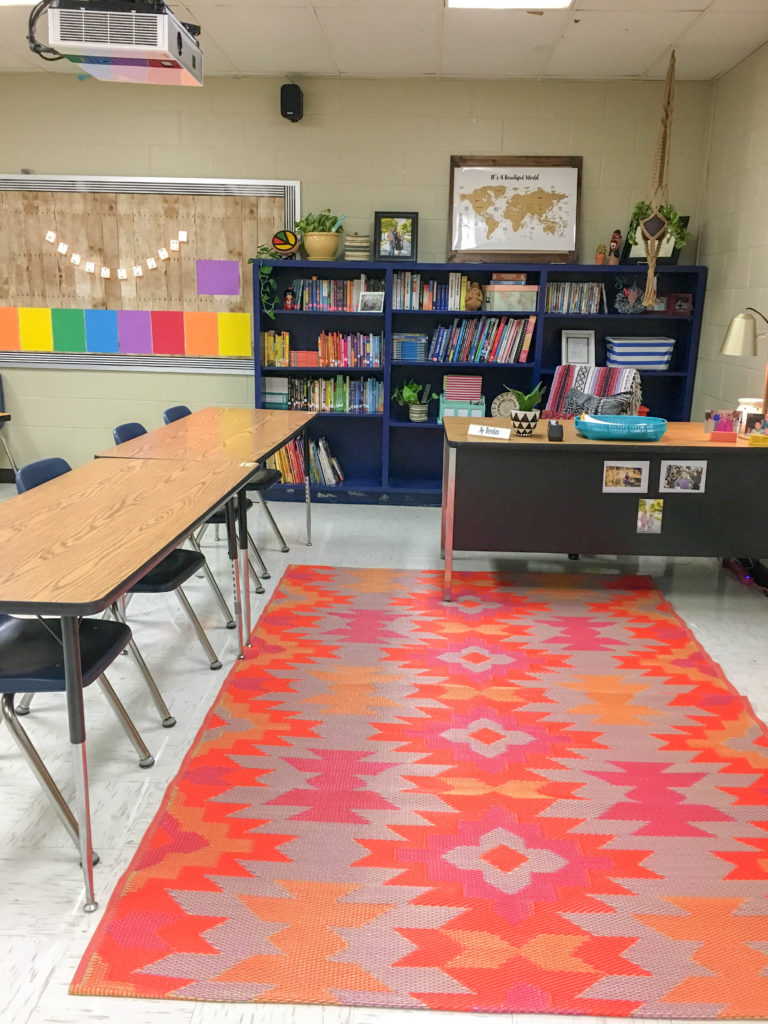 outdoor tribal rug in boho themed classroom with teacher desk in background 