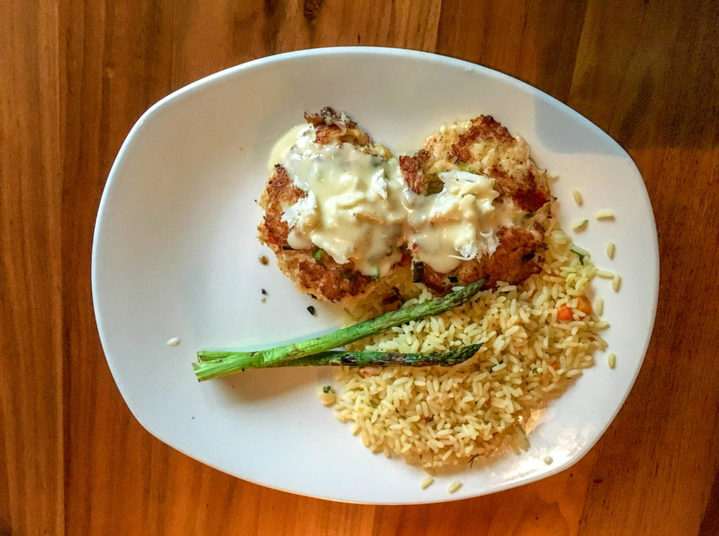 crab cakes with rice pilaf on white plate at Landry's Seafood House on Branson Strip