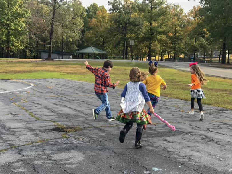 kids running outside at an outdoor playground birthday party