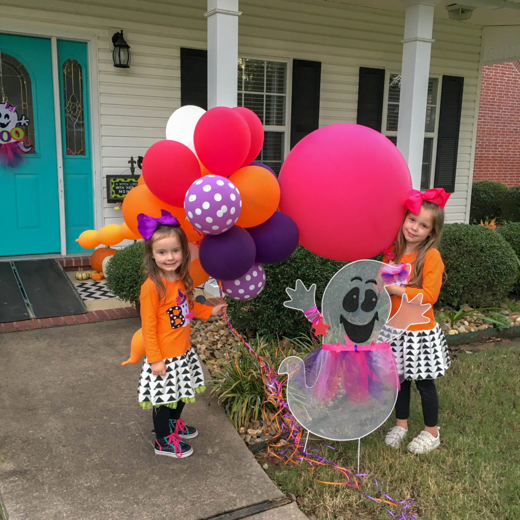 little girls pose with a cute ghost and party balloons after a cute ghost party