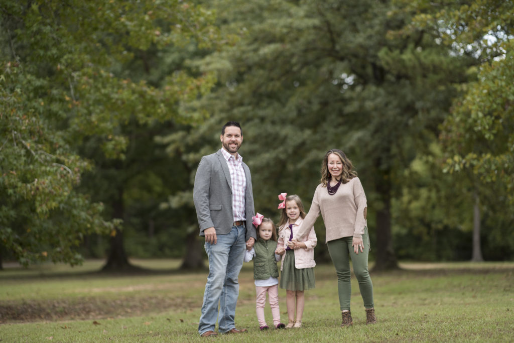 four people pose in fall family photo outfits 