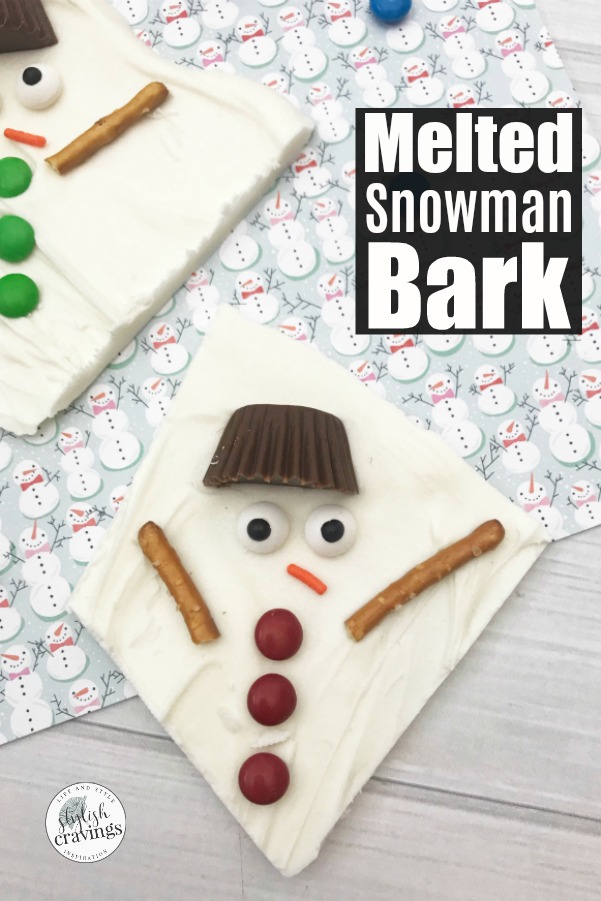 melted snowman bark on snowman backdrop by Delish Cravings