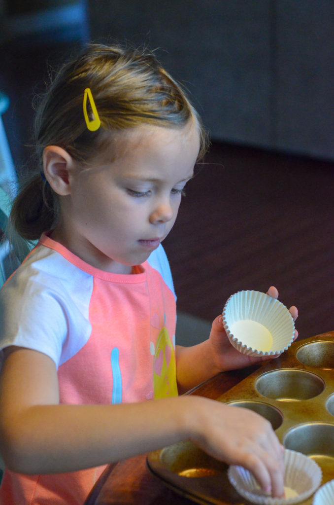 little girl making Mimi's Cafe buttermilk spice muffins