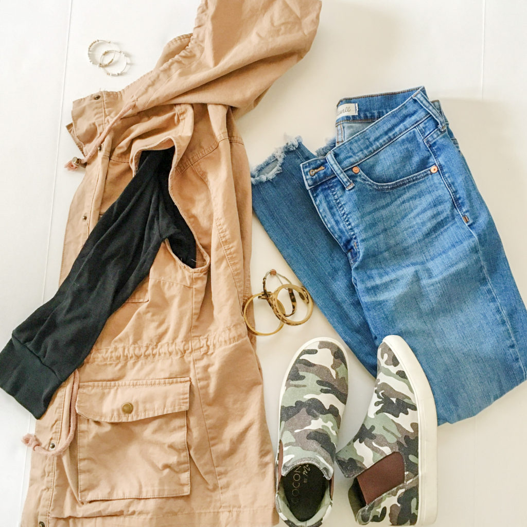 layering outfits flatlay of tan vest, camouflage high tops, and jeans