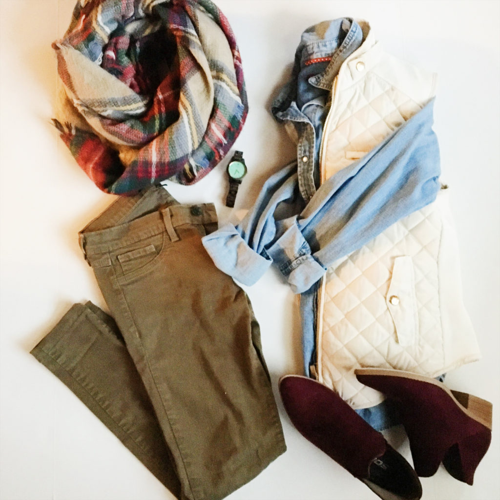 layering clothes outfit flatlay of woman's olive pants with white quilted vest, burgundy booties and plaid scarf