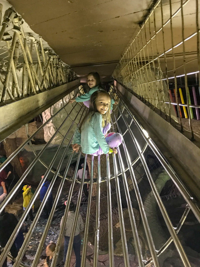 two girls in metal tunnel at City Museum of St. Louis 