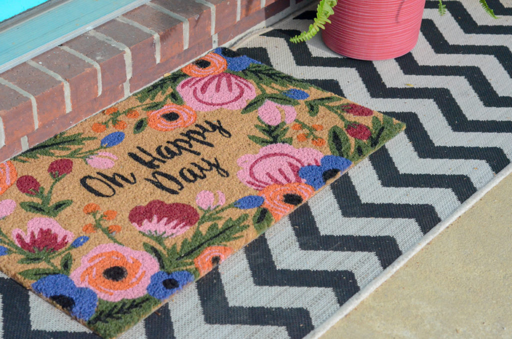 spring front porch rugs - a chevron front porch runner with an "Oh, Happy Day" rug layered on top for spring front porch ideas