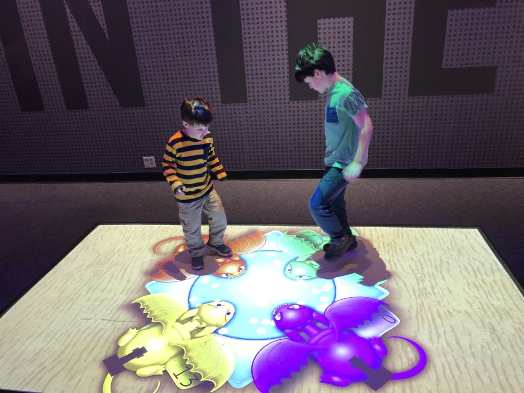 boys on glowing item on floor at Science Museum of St. Louis 