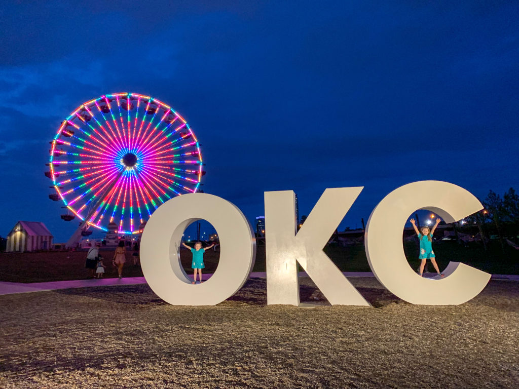 nighttime view of Wheeler Ferris Wheel with large OKC letters - Oklahoma City 