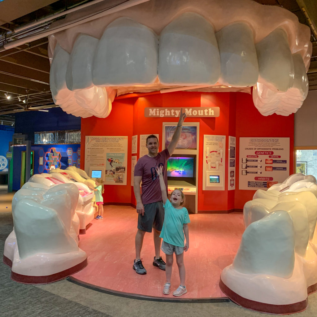 father and daughter standing in Mighty Mouth exhibit at Science Museum Oklahoma