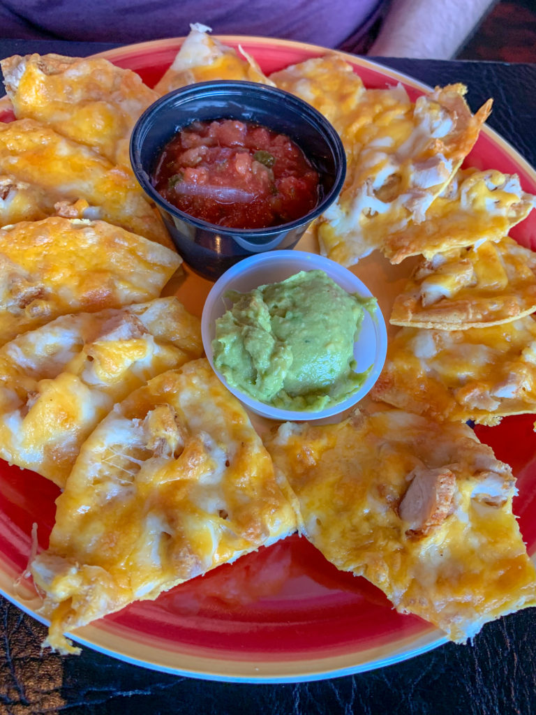 Chicken Nachos on red plate at The Drum Room in Oklahoma City
