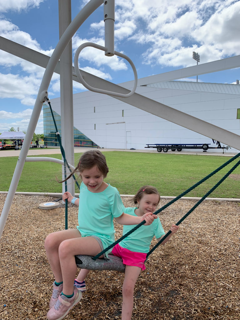 two girls play on RIVERSPORT Youth Zone and playground in Oklahoma City 