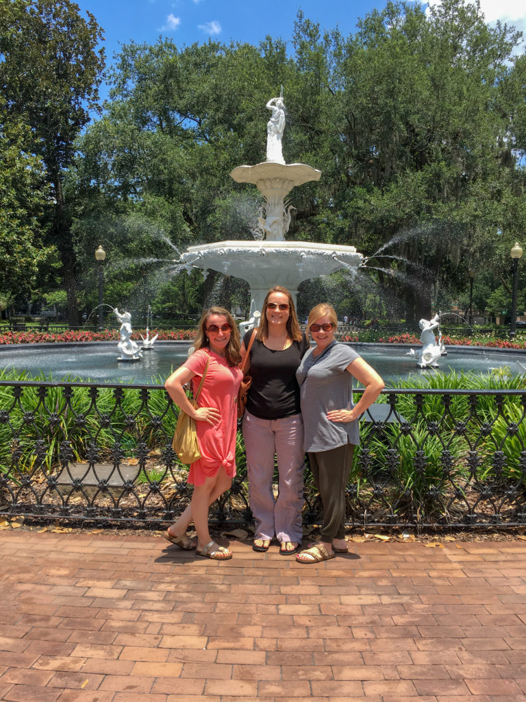 three ladies stand in front of the fountain at Forsyth Park in Savannah, GA during a girls weekend in Savannah