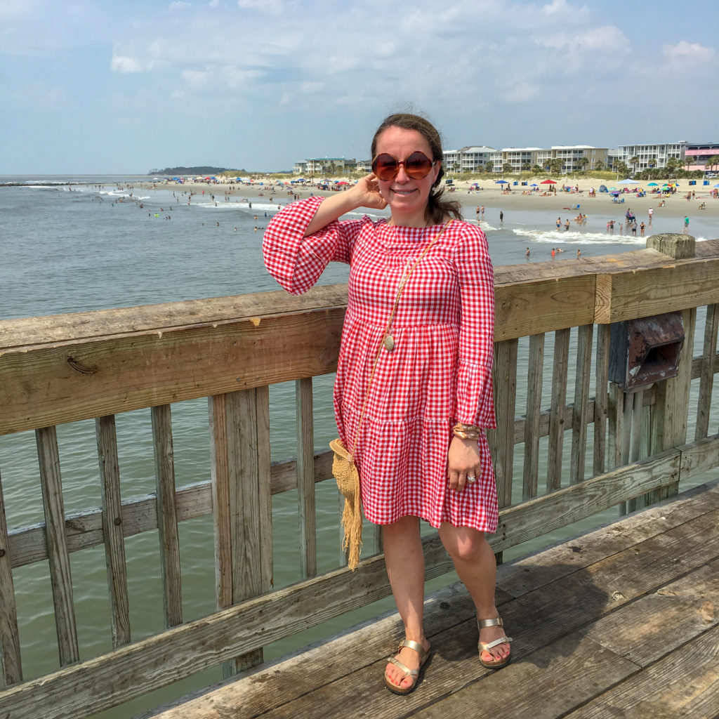 woman in red dress on South Beach on Tybee Island as part of Savannah itinerary plans