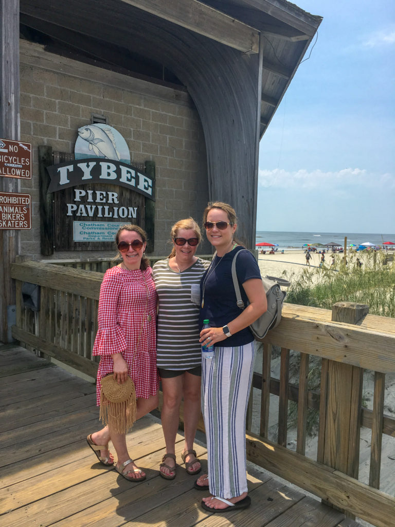 three women on the South Beach pier on Tybee Island during a girls weekend in Savannah