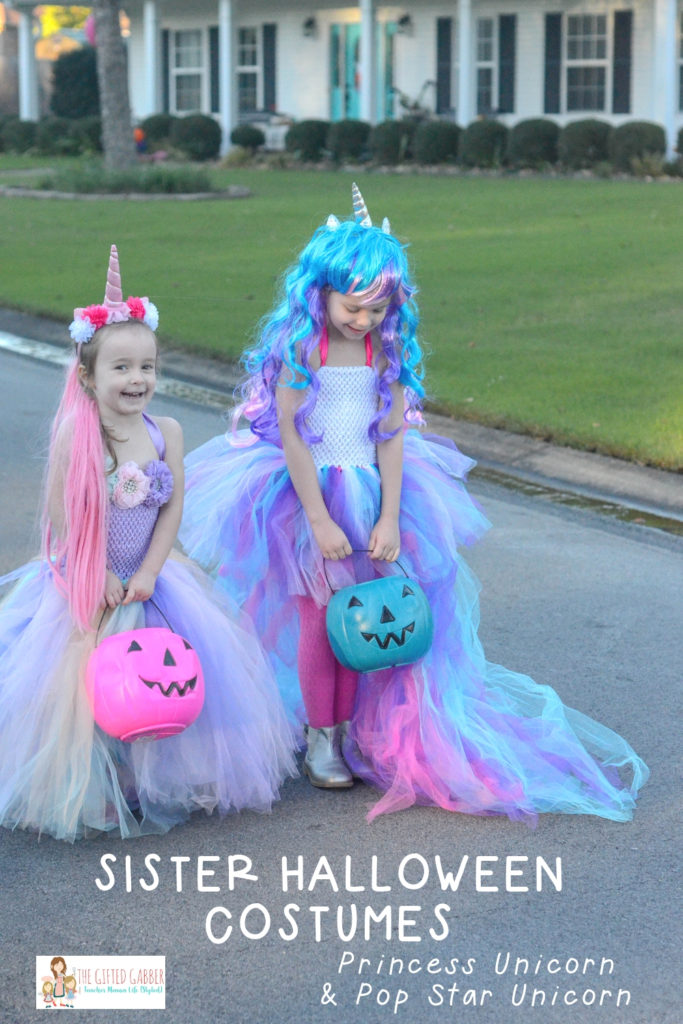 sisters wearing unicorn Halloween costumes 