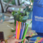 teacher holding Flair Pens in front of school supplies