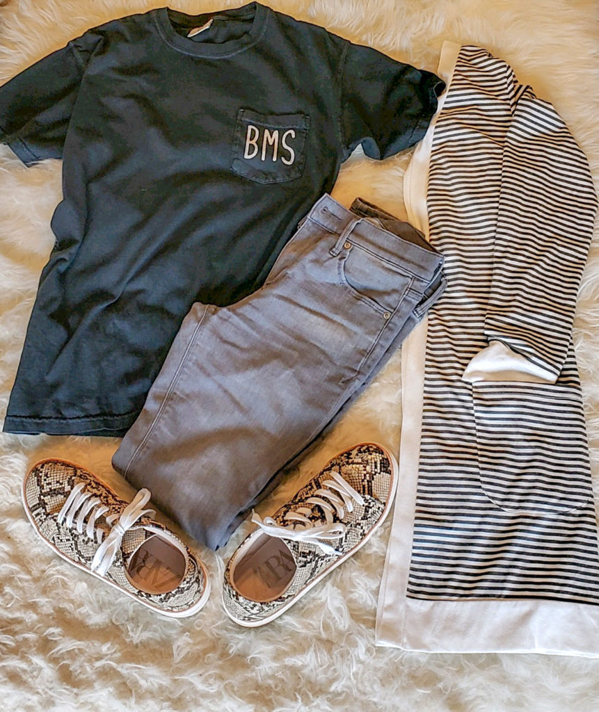 black school spirit t-shirt with gray pants, striped cardigan and snakeskin sneakers