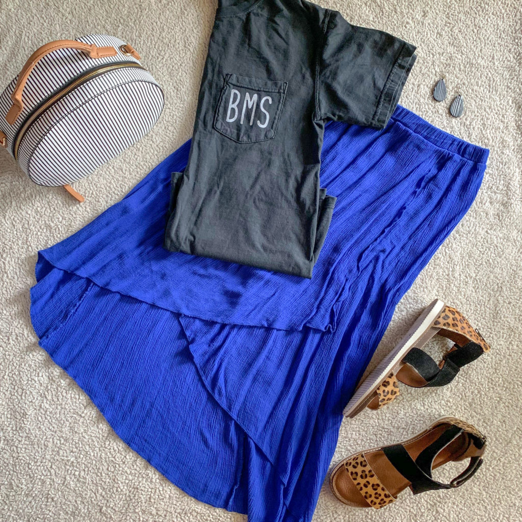 a blue skirt with a school t-shirt and sandals 