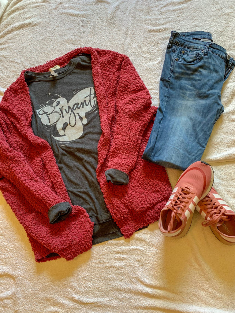 red cardigan with school t-shirt, jeans and red tennis flay lay 