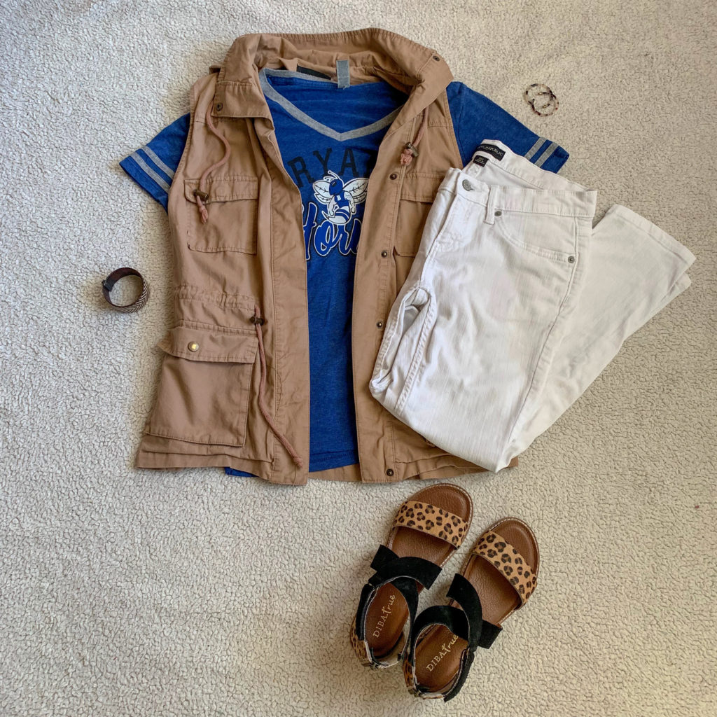 tan utility vest layered over t-shirt with white jeans and leopard sandals 