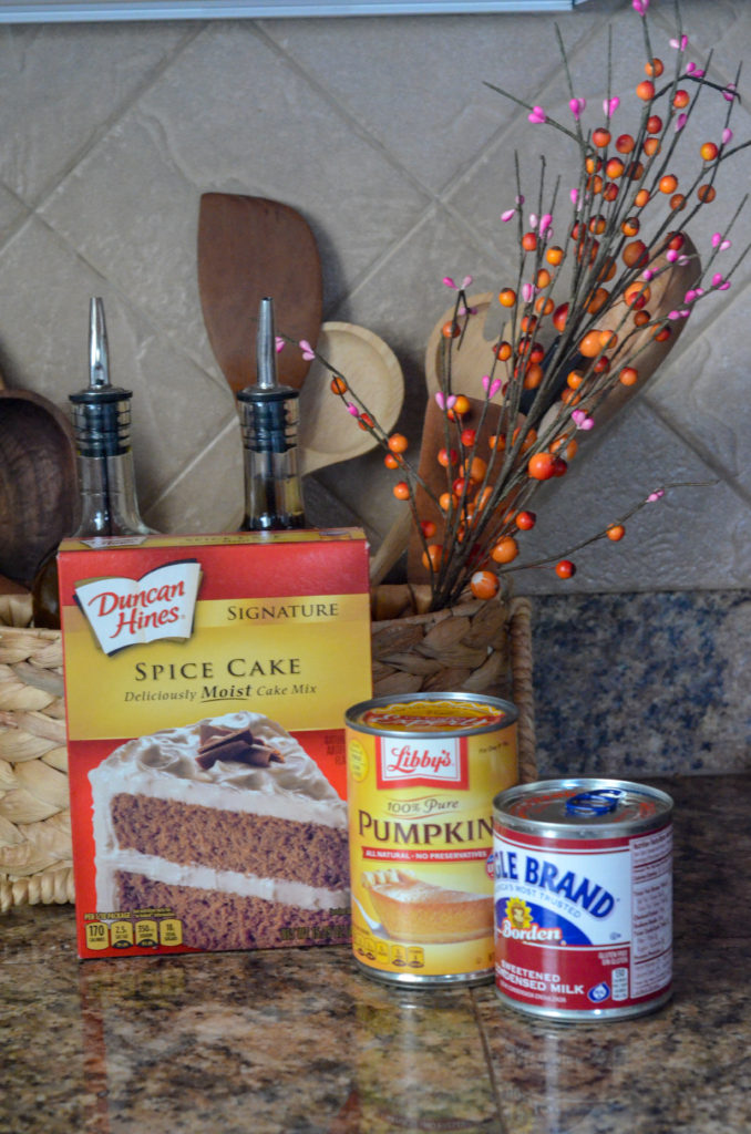 spice cake mix and other ingredients on counter for pumpkin poke cake