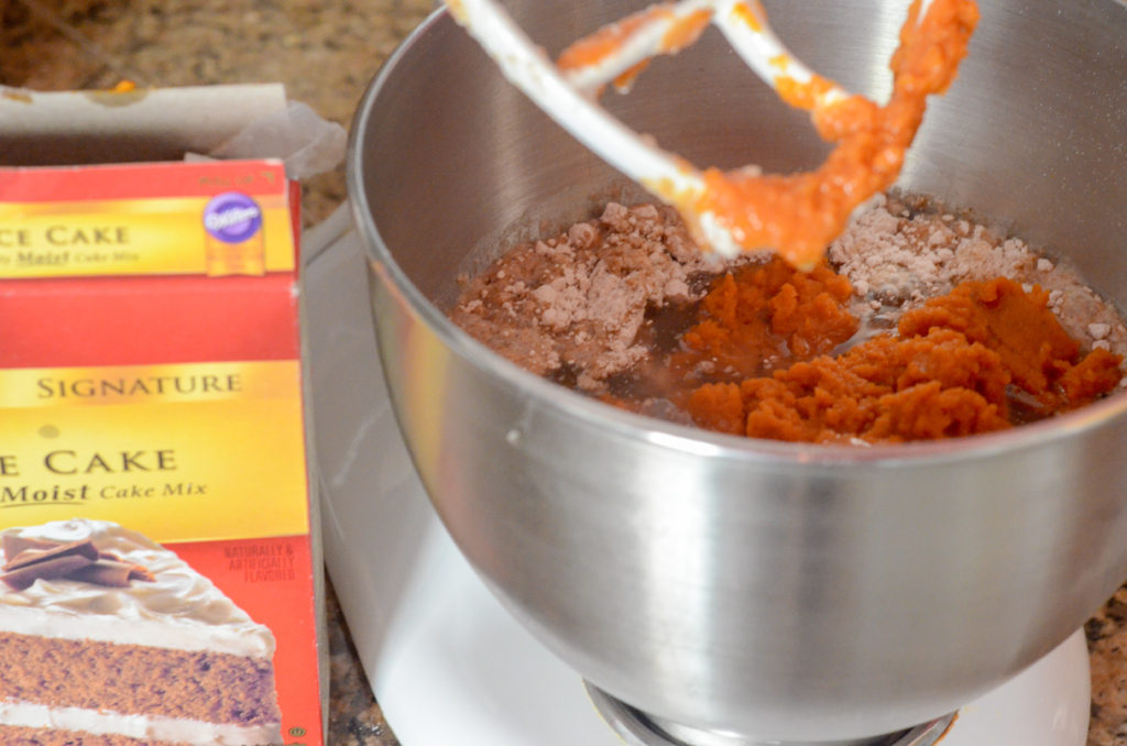 pumpkin spice cake mix in bowl of mixer
