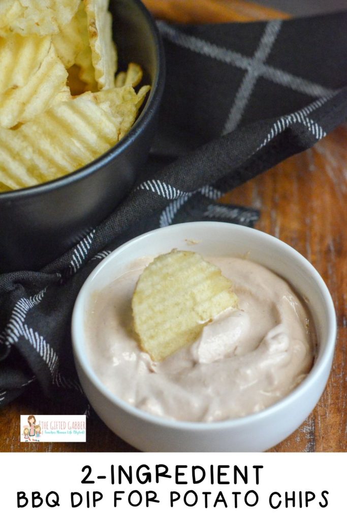 BBQ dip in white bowl beside black bowl of potato chips