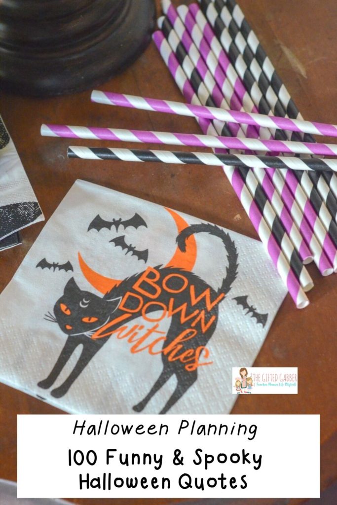 halloween quotes and sayings with black cat and straws on party table 