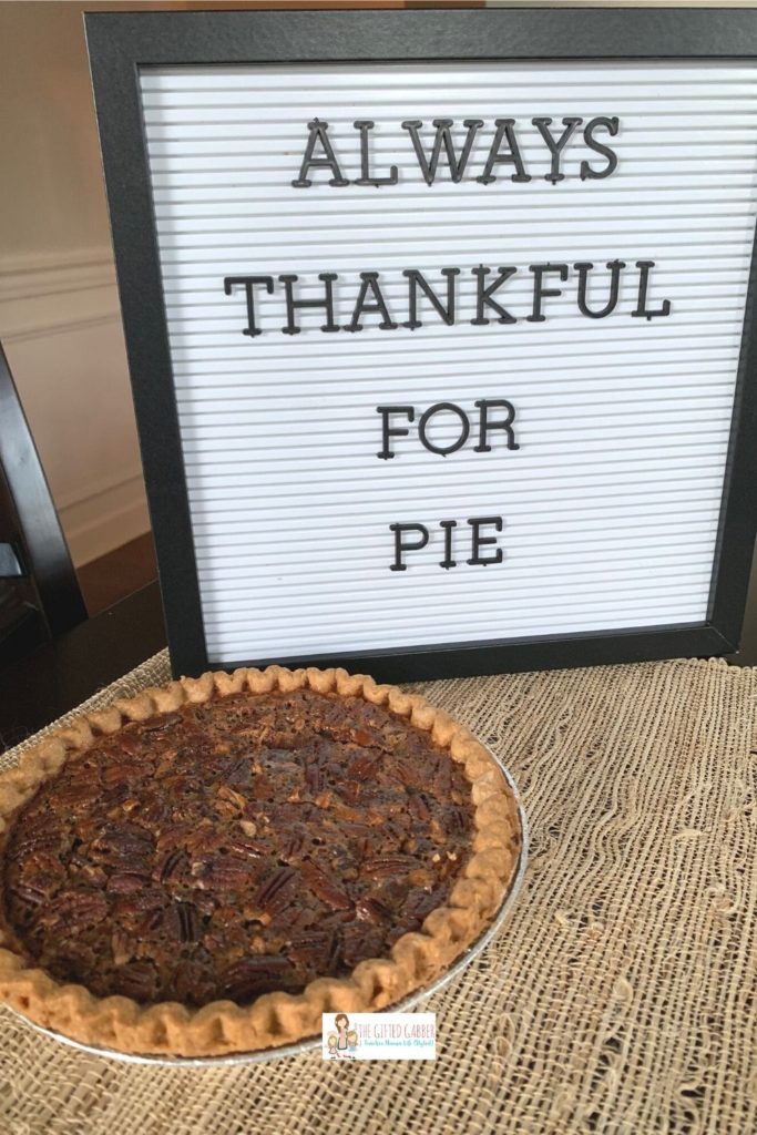 Thanksgiving letter board with a funny Thanksgiving quote and a pecan pie in front 