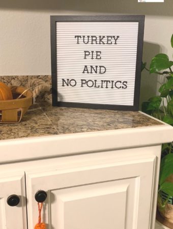 letter board thanksgiving message for friends beside basket of rolls
