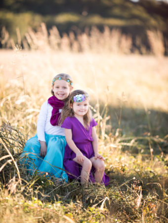 sisters in coordinating blue and purple gypsy bohemian clothing for fall photo shoot