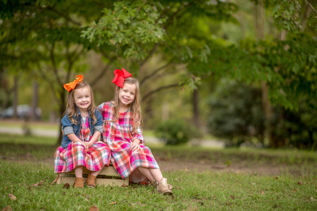 two little girls in matching sisters outfits