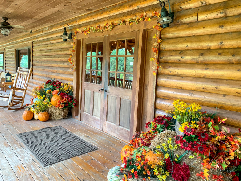 front porch of lodge at Family Farm in Arkansas decked out in fall decor