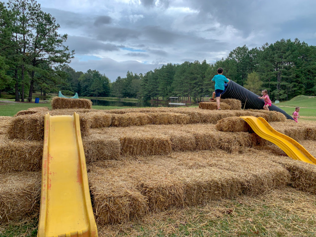 kids play on hay slides at Family Farm in Arkansas