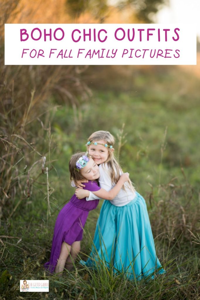 two sisters hugging in field wearing fall boho gypsy clothing in family pictures