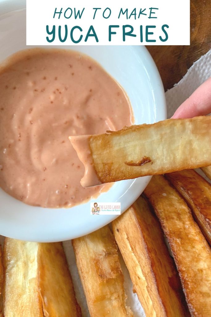 yuca fries dipped into a yuca dip in white bowl 