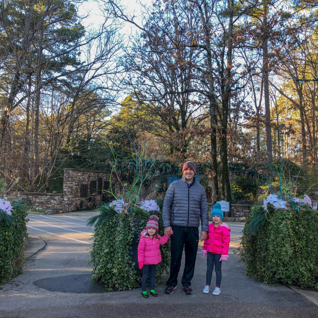 a dad and his daughters stand at entrance to Garvan Gardens