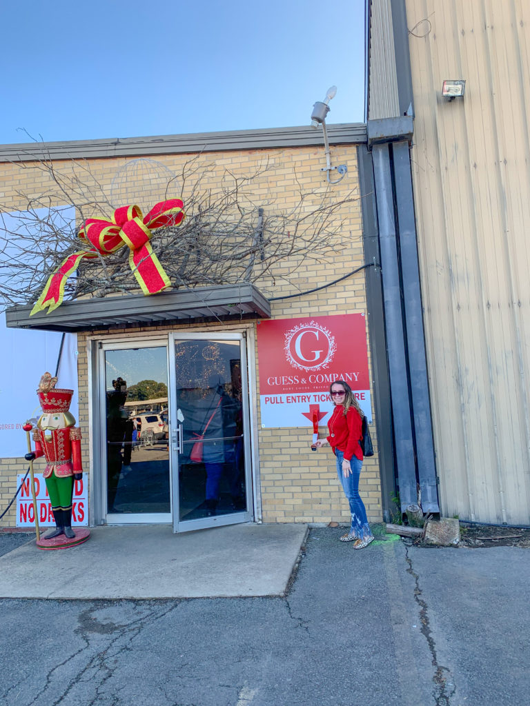 lady takes ticket at Guess and Company Christmas Warehouse sale in Des Arc, AR
