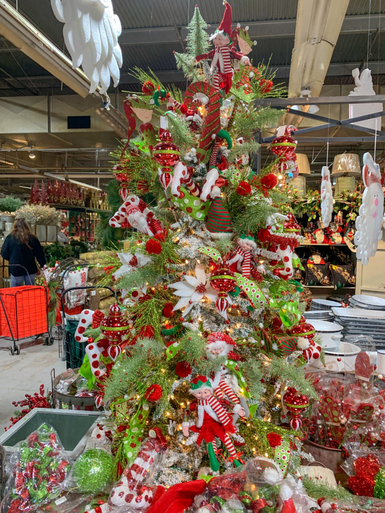 Christmas tree display with poinsettias Christmas decorations and elves 