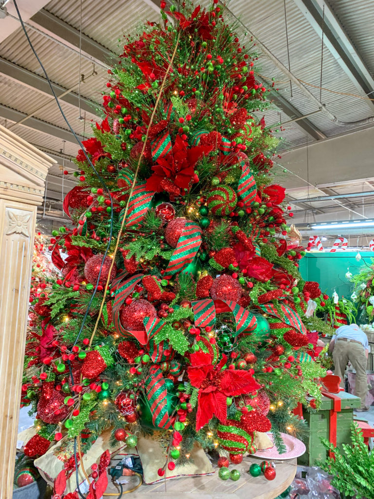 red and green Christmas decorations on decorative trees and Guess and Company Christmas Warehouse