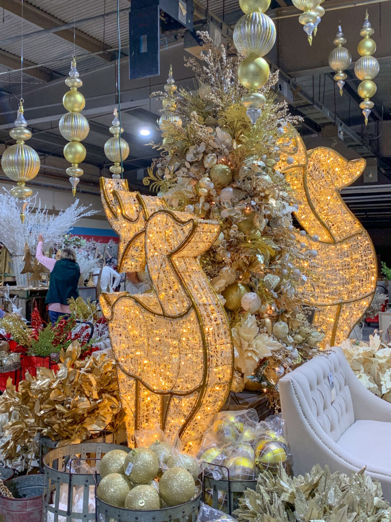 lit reindeer decorations and gold Christmas decorations Christmas display