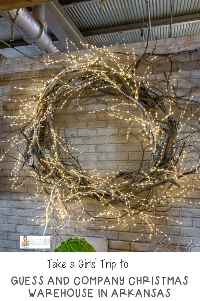 lit farmhouse wreath against brick wall with text overlay