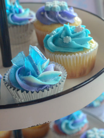 Frozen cupcakes with snowflake decorations for a Frozen themed birthday party at Rave Move Theater in Little Rock, AR