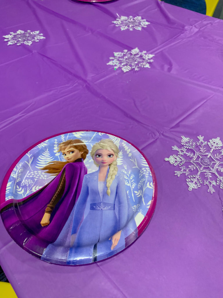 simple Frozen party table with Frozen plates and simple white snowflake ornaments
