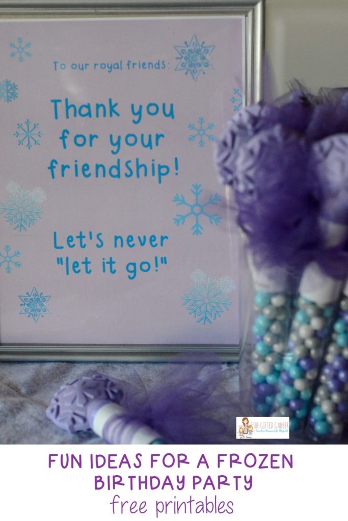 Frozen party favors in glass jar with framed printable in background