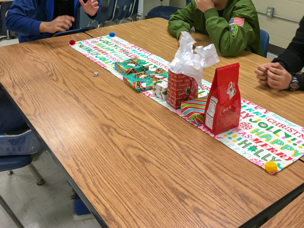 students play Bad Santa game in classroom while following rules for Dirty Santa with dice