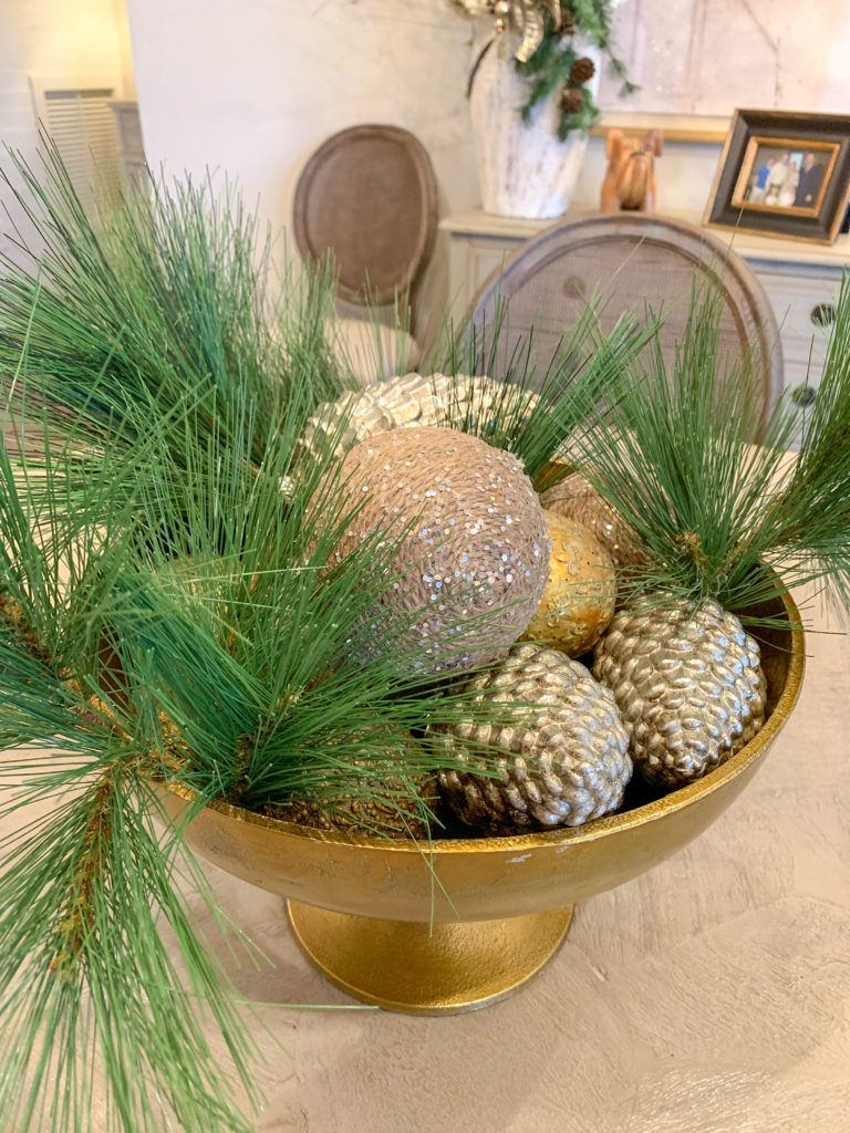 metallic bowl of Christmas ornaments and greenery in modern farmhouse Christmas decorations