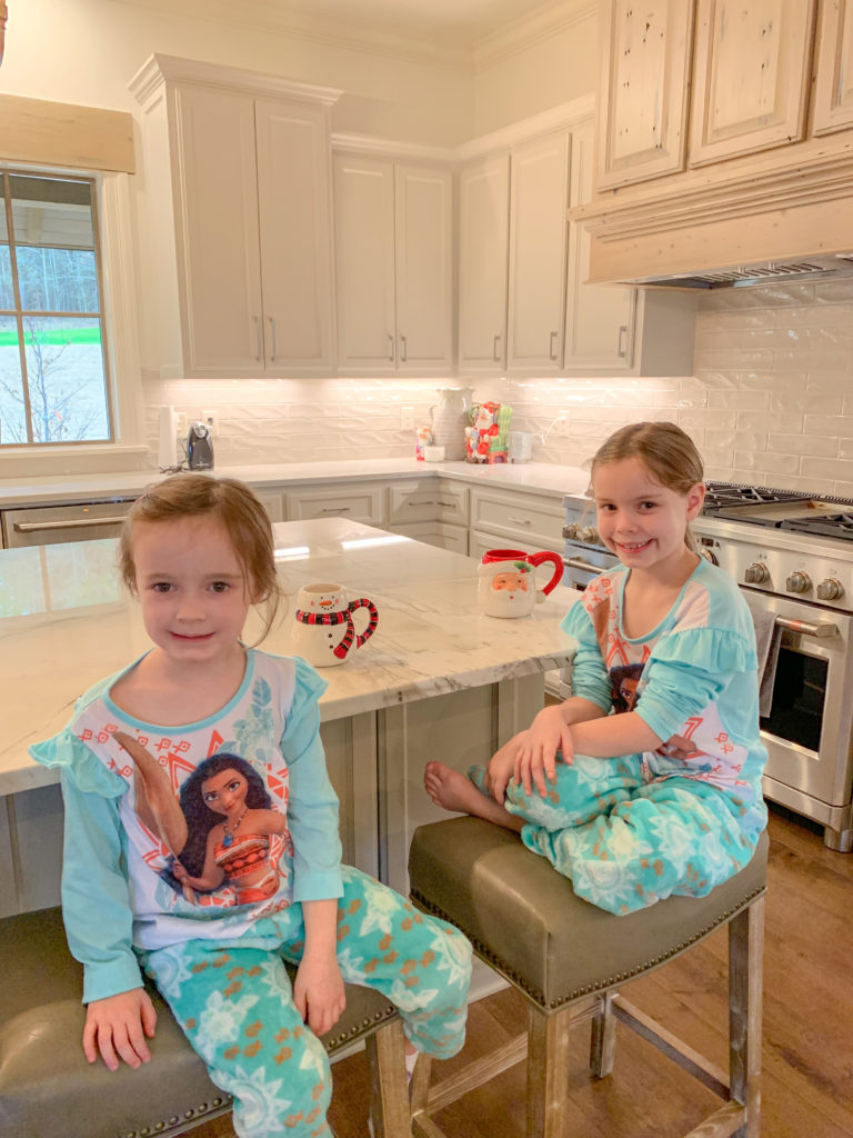 little girls drink hot chocolate in modern farmhouse kitchen
