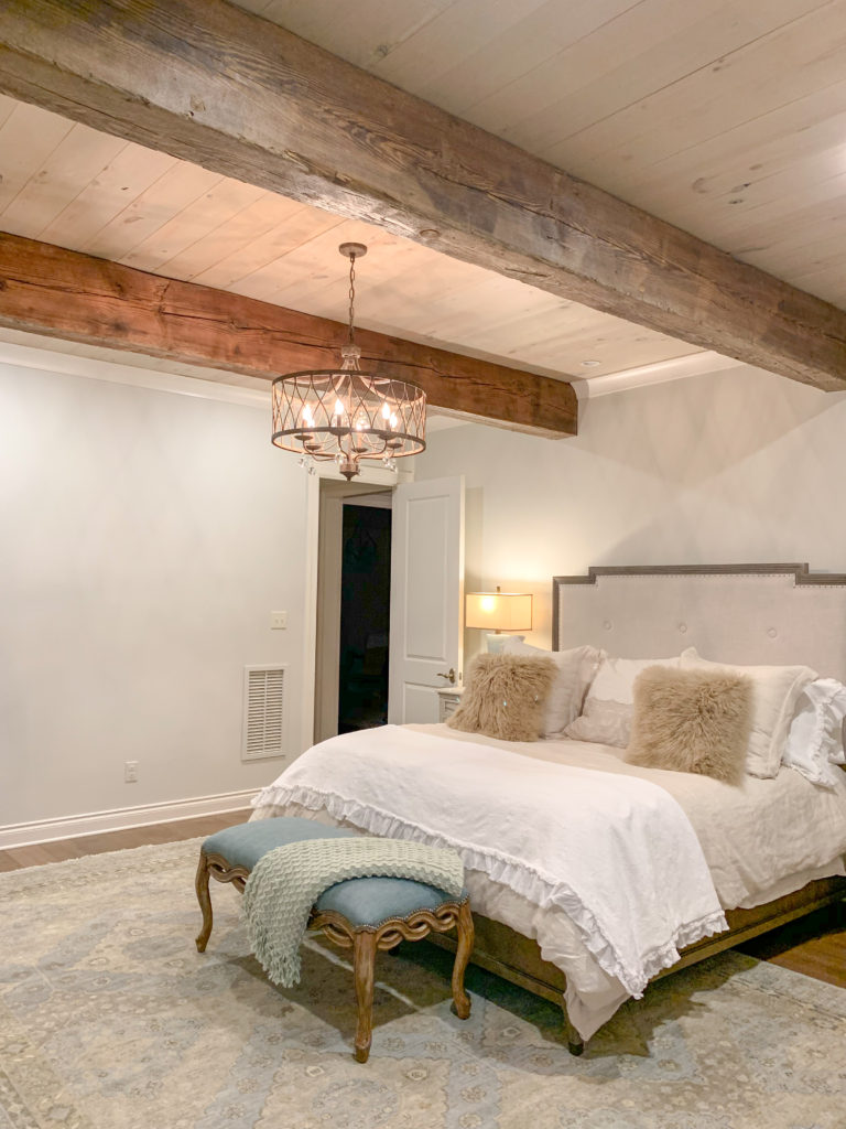 real wood beam ceiling in farmhouse master bedroom 